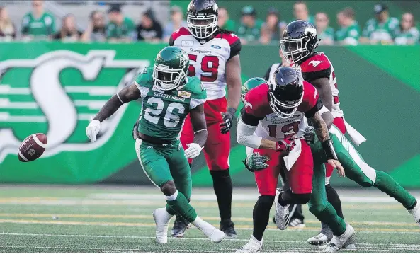  ?? BRANDON HARDER ?? Stampeders QB Bo Levi Mitchell fumbles after being sacked by the Roughrider­s’ Charleston Hughes during Sunday’s CFL game at Mosaic Stadium.