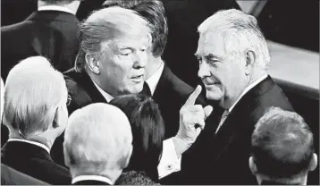  ?? ALEX BRANDON/AP ?? President Donald Trump gestures as he passes Secretary of State Rex Tillerson as he leaves Capitol Hill Tuesday.