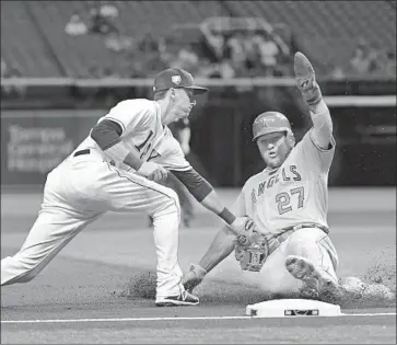  ?? Julio Aguilar Getty Images ?? MIKE TROUT STOLE second in the first inning, but he was tagged out by Matt Duffy trying to steal third.