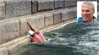  ?? Picture: Gareth Fuller/PA via AP ?? TOUCH DOWN: Lewis Pugh touches Dover harbour wall to complete his ‘Long Swim’ from Land’s End to Dover, England, on Wednesday. The Channel Swimming Associatio­n says he was the first swimmer to do so.