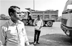  ??  ?? Government workers Zhope, right, and Tandel monitor the papers of debris trucks coming in from Mumbai at Vashi in Navi Mumbai, India, on Feb 2. — WP-Bloomberg photos