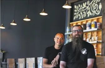  ?? Paul Chinn / The Chronicle ?? Old Kan Beer & Co. co-founders James Syhabout (left) and Adam Lamoreaux in their West Oakland pub. Lamoreaux owned Linden Street Brewery in the same location but has simplified.