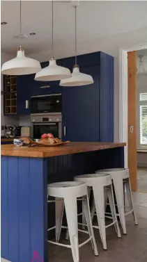  ??  ?? BOLD COLOUR
Deep blue units add a dramatic dash of colour against the dazzling white walls