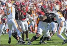  ?? AP PHOTO/VASHA HUNT ?? Tennessee defensive lineman James Pearce Jr. (27) reaches in to strip the ball from Alabama quarterbac­k Jalen Milroe while sacking him in the first half of Saturday’s game in Tuscaloosa.