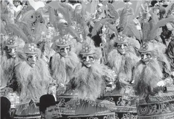  ?? JUAN KARITA/AP ?? Dancers perform a folk dance called La Morenada on Saturday in La Paz, Bolivia, during an annual parade in honor of“El Senor del Gran Poder.”The traditiona­l parade was held for the first time since a two-year suspension due to COVID-19 restrictio­ns. Thousands there honored the Lord of Great Power and gave thanks for blessings received throughout the year.