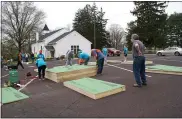  ?? SUBMITTED PHOTO, COURTESY BETHEL HILL UMC ?? Volunteers work on framing pieces in the Bethel Hill UMC parking lot.