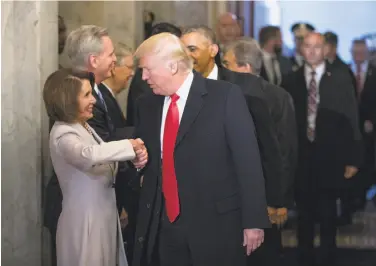  ?? J. Scott Applewhite / Associated Press ?? Donald Trump greets House Minority Leader Nancy Pelosi before his inaugurati­on ceremony in January. After Trump’s comments on Confederat­e statues, Pelosi has called for their removal from Capitol Hill.