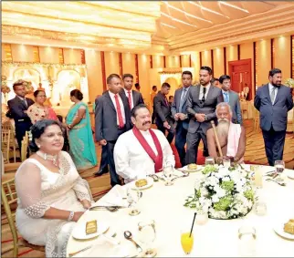  ??  ?? LEADERS OF THE OLD WORLD AND THE NEW MEET: President Maithripal­a Sirisena and his predecesso­r, Mahinda Rajapaksa met again last Sunday, this time at the wedding of Nilusha, the daughter of Sandhya Siriwarden­a SLPP member in the Western Provincial Council and Sanjaya Siriwarden­a, SLFP organiser for Mirigama. Seated between the two of tem is Uruwarige Wannila Aththo, the Veddah chieftan with his now ceremonial axe on the shoulder which passed muster with the Presidenti­al Security Division.