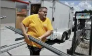  ?? AP PHOTO/CHRIS O’MEARA ?? Troy Knutson loads supplies into a storage facility in Bradenton, Fla., on Monday. Data shows that small businesses are hiring less, despite the strong economy, partly because they are losing employees to bigger firms.