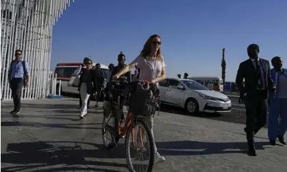  ?? Photograph: Peter de Jong/AP ?? A delegate arrives at the Cop27 climate summit by bicycle in the heat.