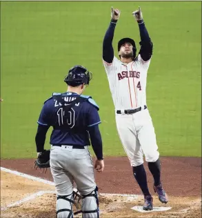  ?? Ashley Landis / Associated Press ?? Tampa Bay Rays catcher Mike Zunino watches as the Houston Astros’ George Springer celebrates his two-run home run against the Tampa Bay Rays during the fifth inning in Game 4 of the American League Championsh­ip Series on Wednesday.