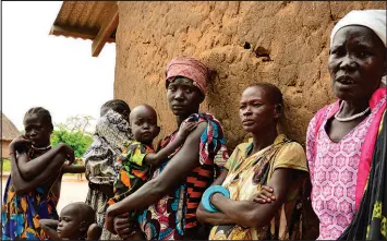  ?? MARIAH QUESADA / AP FILE (2017) ?? Women and children are seen Oct. 4, 2017, in Terekeka, South Sudan. The number of people infected with Guinea worm dropped to just over a dozen worldwide in 2022 as health workers worked to eradicate the disease.