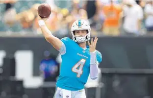  ?? AARON DOSTER/AP ?? Dolphins quarterbac­k Reid Sinnett throws before Sunday’s preseason game against the Bengals in Cincinnati.