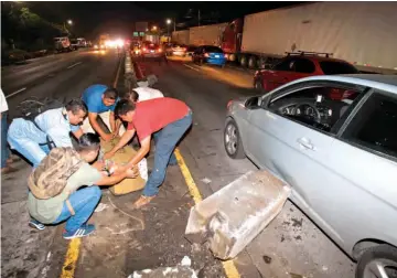  ??  ?? Choques. Automovili­stas retiran los separadore­s centrales de la carretera Los Chorros, en la zona de Las Delicias, de Santa Tecla, donde una rastra impactó contra un microbús particular. No hubo lesionados.