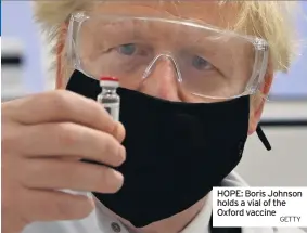  ?? GETTY ?? HOPE: Boris Johnson holds a vial of the Oxford vaccine