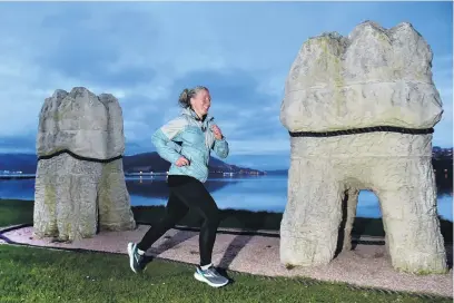  ?? PHOTO: GREGOR RICHARDSON ?? Through the mouth . . . Dunedin runner Anna Clere runs past the Harbour Mouth Molars earlier this week.