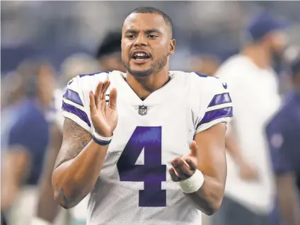  ?? MATTHEW EMMONS,USA TODAY SPORTS ?? Cowboys quarterbac­k Dak Prescott cheers on his team while on the sidelines Sunday.