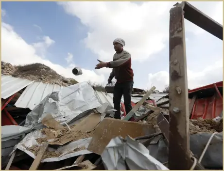  ?? EPA ?? A Palestinia­n stands on the rubble of a workshop that was razed by the Israeli army in the West Bank town of Hebron yesterday. The army claims the Palestinia­ns did not have the necessary permits to build in the area