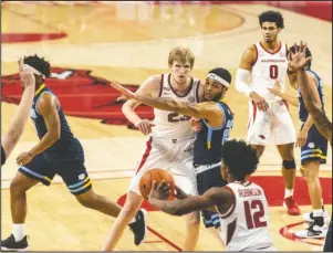  ?? Special to the NWA Democrat-Gazette/David Beach ?? REACHING OUT: Arkansas’ Connor Vanover (23) looks for the ball as Southern’s Andre Allen (22) defends at Bud Walton Arena on Dec. 9.