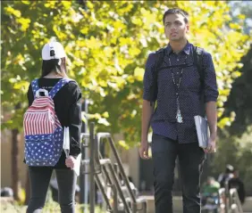  ?? Paul Chinn / The Chronicle ?? Neeraj Dharmadhik­ari walks to his next class at De Anza College. The dependents of H-1B visa holders, sometimes called “H-4 Dreamers,” face having to leave the country where they grew up.