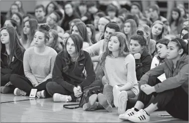  ?? TIM MARTIN/THE DAY ?? Students at Stonington High School attend a school assembly in the gymnasium Wednesday to honor the 17 victims killed Feb. 14 in the mass shooting at the Marjory Stoneman Douglas High School in Parkland, Fla. The names of the shooting victims were read...