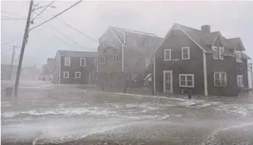  ?? PIC AFP ?? Waves crashing into homes in a coastal area in Scituate, Massachuse­tts, on Friday.