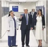  ?? JORDAN FABIAN/ POOL/ EPA- EFE ?? President Trump is accompanie­d by his wife Melania and surgeon Igor Nichiporen­ko during a visit to school shooting victims.