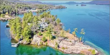  ?? Photos by Spencer Bray of Realize Brokers ?? Green Harbour Mansion on Cooper Point in Lake George is on the market for $8.4 million, a steep drop from when it was last listed in 2019 for $15 million.