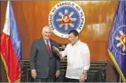  ?? BULLIT MARQUEZ / AP ?? U.S. Secretary of State Rex Tillerson, left, is welcomed by Philippine President Rodrigo Duterte at Malacanang Palace in Manila on Monday. Both attended the 50th ASEAN Foreign Ministers Meeting.