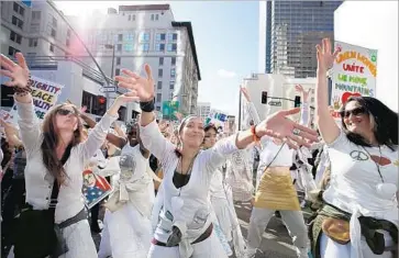  ?? Francine Orr Los Angeles Times ?? WOMEN dance during the march. Participan­ts advocated for women, defended the environmen­t and lobbied for immigrants, Muslims, gays and the disabled — groups widely seen as vulnerable under the new president.