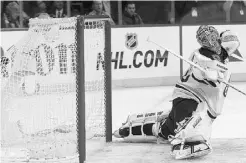  ?? SETH WENIG/ THE ASSOCIATED PRESS ?? Boston’s Tuukka Rask watches as the overtime-winning goal by New York’s Chris Kreider gets past him in Thursday’s Game 4.