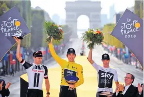  ??  ?? REUTERS Team Sky rider Geraint Thomas of Britain (C), wearing the overall leader’s yellow jersey, celebrates on the podium after the final stage of Tour de France in Champs-elysees in Paris, France, on July 29, 2018.