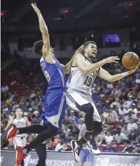  ??  ?? LAS VEGAS: Los Angeles Clippers’ Luke Nelson, right, goes to the basket as Golden State Warriors’ Tai Webster defends during an NBA summer league basketball game in Las Vegas on Friday. — AP