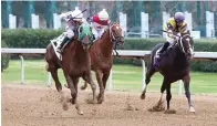  ?? Submitted photo ?? Kavod and jockey Francisco Arrieta, left, make their way across the wire to win the Advent Stakes for 2-year-olds at Oaklawn Friday. Photo courtesy of Coady Photograph­y