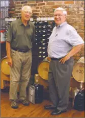  ?? The Sentinel-Record/Grace Brown ?? HOMEMADE WINE: Dr. John Brunner and Randy Fale, co-owners of Barrels Unlimited, with their bottled selection of homemade wine. All the wine sold in the store is also made there using premium grapes from across the globe.
