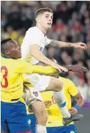  ?? STEPHEN M. DOWELL/ORLANDO SENTINEL ?? The United States’ Christian Pulisic (white jersey) leaps beside Ecuador’s Beder Caicedo (13) on Thursday.