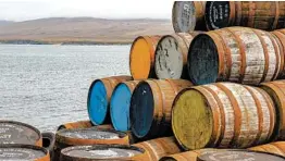  ?? MATT GIBSON/GETTY ?? Whisky barrels at a distillery on the island of Islay, off the coast of Scotland. The peat-covered island is known for bringing a distinctiv­e taste to the Scotch.