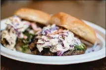  ?? CONTRIBUTE­D BY HENRI HOLLIS ?? Botiwalla lamb burgers at Ponce City Market feature pronounced Indian flavors.