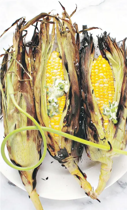  ??  ?? A turn on the grill adds a smoky accent to Lindsay Anderson’s and Dana VanVeller’s barbecued corn on the cob with chives and garlic butter. Feel free to substitute whichever fresh herbs that you like.