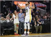  ?? JEFF CHIU — THE ASSOCIATED PRESS ?? Golden State Warriors guard Stephen Curry celebrates after scoring against the Denver Nuggets during the second half of a preseason game in San Francisco on Friday.