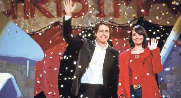  ?? PHOTOS BY PETER MOUNTAIN/UNIVERSAL STUDIOS ?? The secret’s out for David (Hugh Grant) and Natalie (Martine McCutcheon) in “Love Actually.”