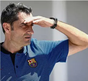  ??  ?? Sun gets in my eyes: Barcelona coach Ernesto Valverde observing a training session at the Joan Gamper Sports Centre in Barcelona, Spain, yesterday. — AP
