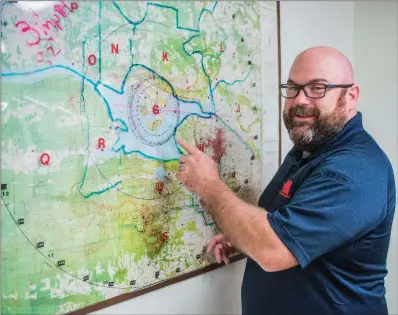  ?? WILLIAM HARVEY/RIVER VALLEY & OZARK EDITION ?? Jeff Gilkey of Danville, director of the Yell County Office of Emergency Management, points out zones on the nuclear-preparedne­ss map in his office. Gilkey was named State Emergency Management Coordinato­r of the Year by the Arkansas Department of...