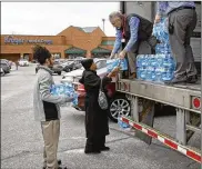  ?? STAFF / FILE 2019 ?? Free bottled water was distribute­d at Kroger locations throughout Montgomery County in February 2019. A large water main break cut water service to much of the county.