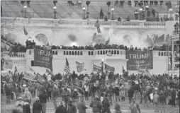  ?? JOHN MINCHILLO/AP ?? In this Jan. 6. 2021, file photo, people storm the Capitol in Washington. A blistering internal report by the U.S. Capitol Police describes a multitude of missteps that left the force unprepared for the Jan. 6 insurrecti­on.