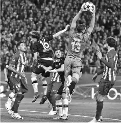  ??  ?? Atletico Madrid’s Jan Oblak stops a ball during the UEFA Champions League round of 16 second leg match against Bayer Leverkusen at the Vicente Calderon stadium in Madrid. — AFP photo