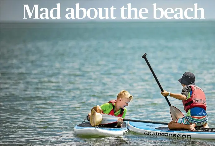  ??  ?? Brothers Simon and Mati Dziubek, above, might disagree over whether surfing or paddle-boarding is more fun – but they agree that messing about on the water is an essential part of a Kiwi holiday. And if the sight of so many paddleboar­ds on Tahunanui beach, right, are anything to go by, they’re not wrong!