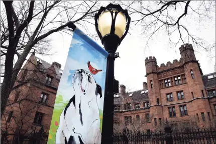  ?? Arnold Gold / Hearst Connecticu­t Media ?? Above, a spring banner is displayed Tuesday outside Vanderbilt Hall on Yale University’s Old Campus in New Haven, where commenceme­nt is held in the spring. Below, one of the gates to the Old Campus.