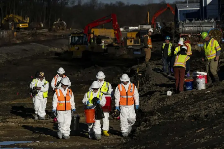  ?? Michael Swensen/Getty Images ?? EPA contractor­s collect soil and air samples from the derailment site in East Palestine, Ohio, on March 9.