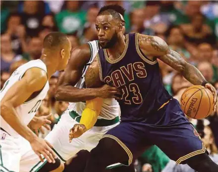  ?? AFP PIC ?? Cavaliers’ LeBron James (right) tries to go past Celtics players during game one of the Eastern Conference finals in Boston on Wednesday.